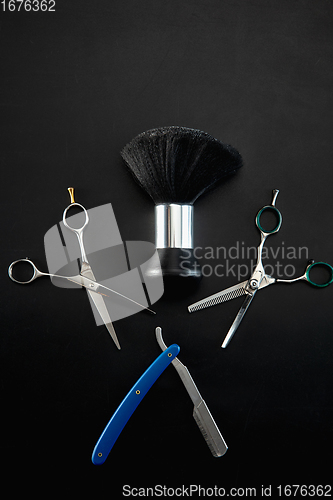 Image of Barber shop equipment set isolated on black table background.