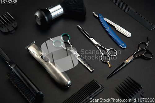 Image of Barber shop equipment set isolated on black table background.