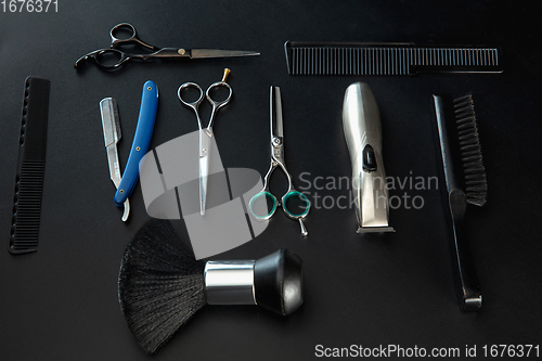 Image of Barber shop equipment set isolated on black table background.