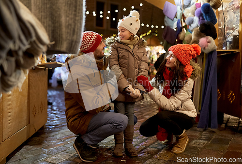 Image of happy family at christmas market in city