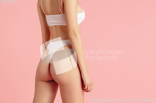 Image of Beautiful female body on pink background. Beauty, cosmetics, spa, depilation, diet and treatment, fitness concept.