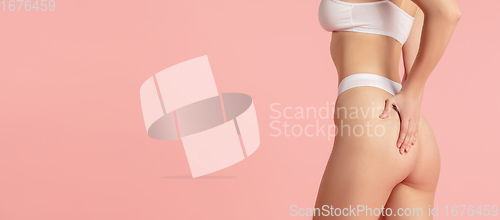 Image of Beautiful female body on pink background. Beauty, cosmetics, spa, depilation, diet and treatment, fitness concept.
