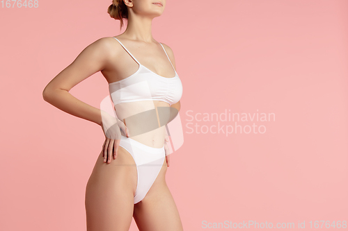 Image of Beautiful female body on pink background. Beauty, cosmetics, spa, depilation, diet and treatment, fitness concept.