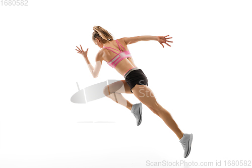 Image of Caucasian professional female runner, athlete training isolated on white studio background. Copyspace for ad.