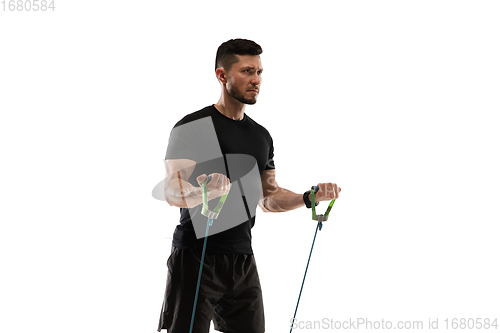 Image of Caucasian professional sportsman training isolated on white studio background. Muscular, sportive man practicing.