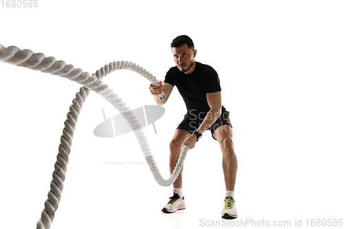 Image of Caucasian professional sportsman training isolated on white studio background. Muscular, sportive man practicing.