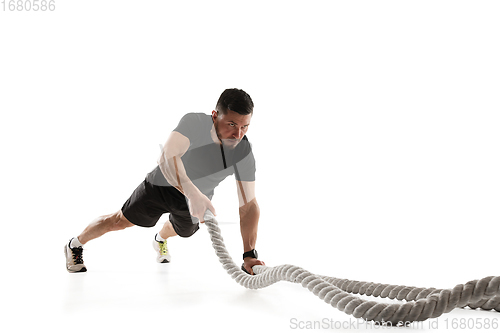 Image of Caucasian professional sportsman training isolated on white studio background. Muscular, sportive man practicing.