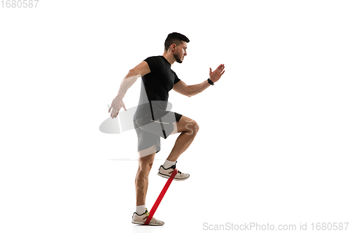 Image of Caucasian professional sportsman training isolated on white studio background. Muscular, sportive man practicing.