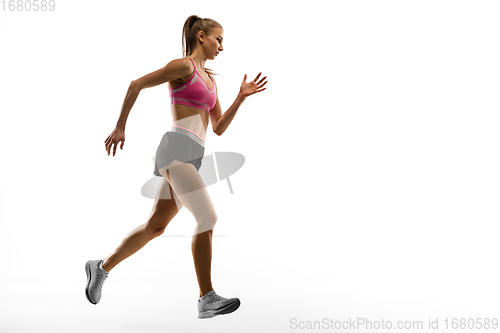 Image of Caucasian professional female runner, athlete training isolated on white studio background. Copyspace for ad.