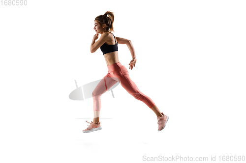 Image of Young caucasian female model in action, motion isolated on white background. Concept of sport, movement, energy and dynamic, healthy lifestyle. Training, practicing.