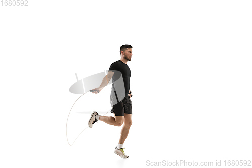 Image of Caucasian professional sportsman training isolated on white studio background. Muscular, sportive man practicing.