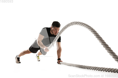 Image of Caucasian professional sportsman training isolated on white studio background. Muscular, sportive man practicing.