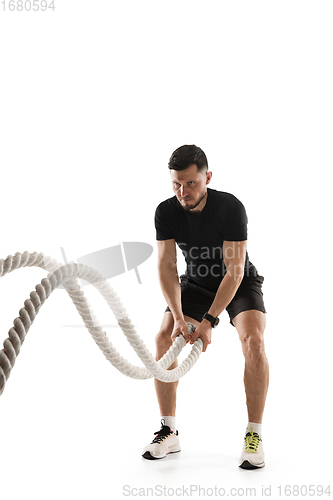 Image of Caucasian professional sportsman training isolated on white studio background. Muscular, sportive man practicing.