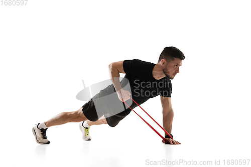 Image of Caucasian professional sportsman training isolated on white studio background. Muscular, sportive man practicing.