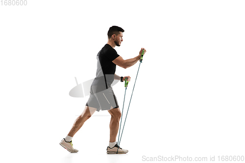 Image of Caucasian professional sportsman training isolated on white studio background. Muscular, sportive man practicing.