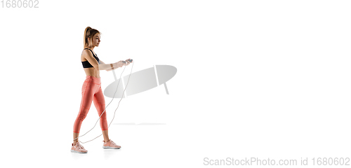 Image of Young caucasian female model in action, motion isolated on white background. Concept of sport, movement, energy and dynamic, healthy lifestyle. Training, practicing.