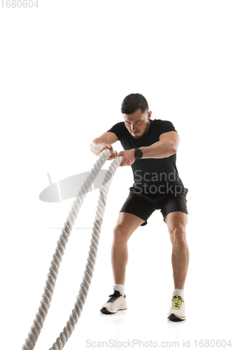 Image of Caucasian professional sportsman training isolated on white studio background. Muscular, sportive man practicing.