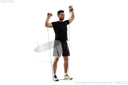 Image of Caucasian professional sportsman training isolated on white studio background. Muscular, sportive man practicing.