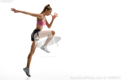 Image of Caucasian professional female runner, athlete training isolated on white studio background. Copyspace for ad.