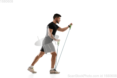 Image of Caucasian professional sportsman training isolated on white studio background. Muscular, sportive man practicing.