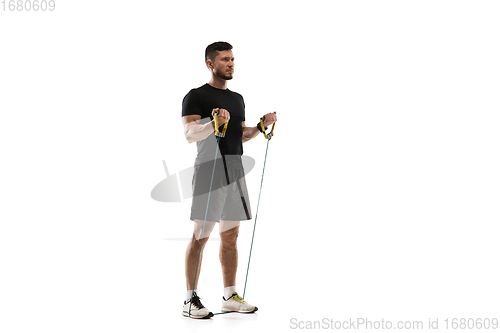 Image of Caucasian professional sportsman training isolated on white studio background. Muscular, sportive man practicing.