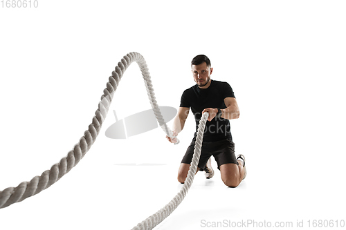 Image of Caucasian professional sportsman training isolated on white studio background. Muscular, sportive man practicing.