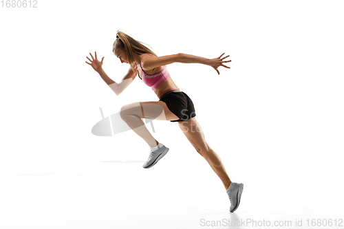 Image of Caucasian professional female runner, athlete training isolated on white studio background. Copyspace for ad.