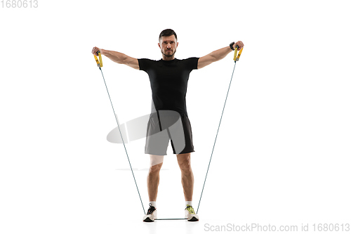 Image of Caucasian professional sportsman training isolated on white studio background. Muscular, sportive man practicing.