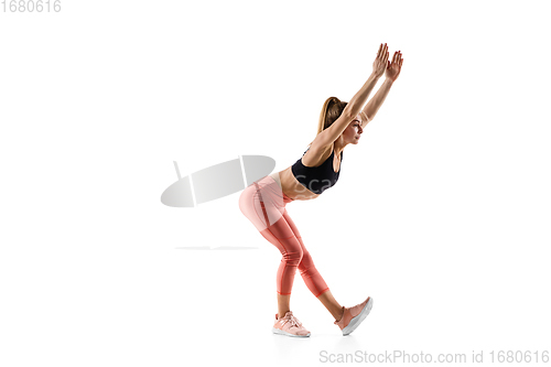 Image of Young caucasian female model in action, motion isolated on white background. Concept of sport, movement, energy and dynamic, healthy lifestyle. Training, practicing.