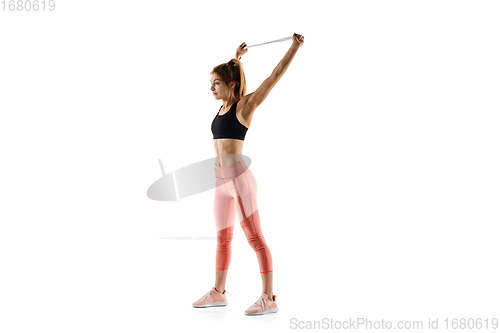 Image of Young caucasian female model in action, motion isolated on white background. Concept of sport, movement, energy and dynamic, healthy lifestyle. Training, practicing.