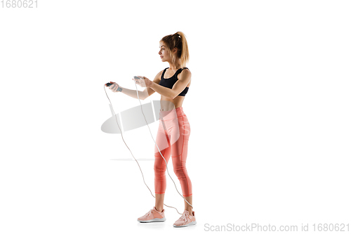 Image of Young caucasian female model in action, motion isolated on white background. Concept of sport, movement, energy and dynamic, healthy lifestyle. Training, practicing.