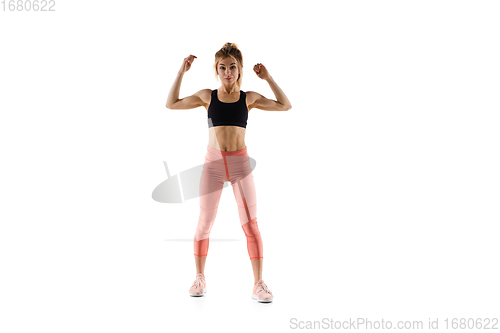 Image of Young caucasian female model in action, motion isolated on white background. Concept of sport, movement, energy and dynamic, healthy lifestyle. Training, practicing.