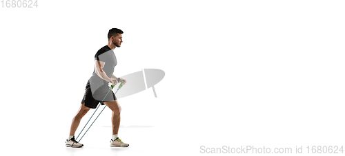 Image of Caucasian professional sportsman training isolated on white studio background. Muscular, sportive man practicing.