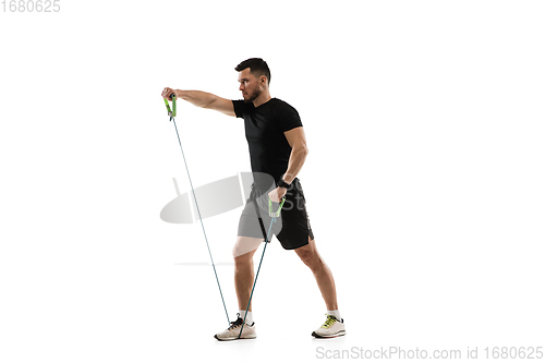 Image of Caucasian professional sportsman training isolated on white studio background. Muscular, sportive man practicing.