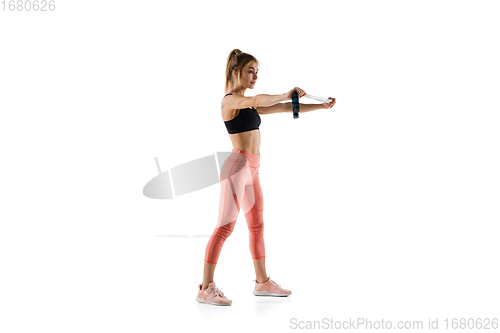 Image of Young caucasian female model in action, motion isolated on white background. Concept of sport, movement, energy and dynamic, healthy lifestyle. Training, practicing.