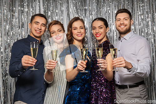 Image of happy friends toasting champagne glasses at party