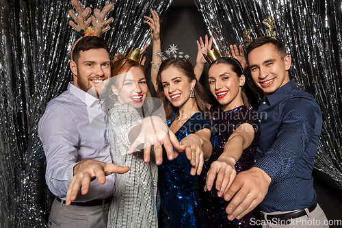 Image of happy friends posing at christmas party