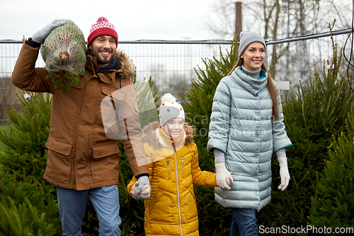 Image of happy family buying christmas tree at market