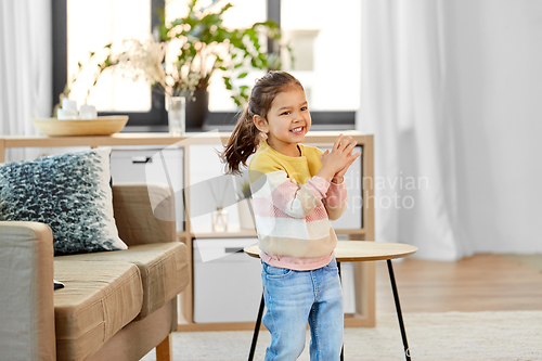 Image of happy smiling little girl at home