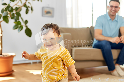 Image of happy baby boy with father at home