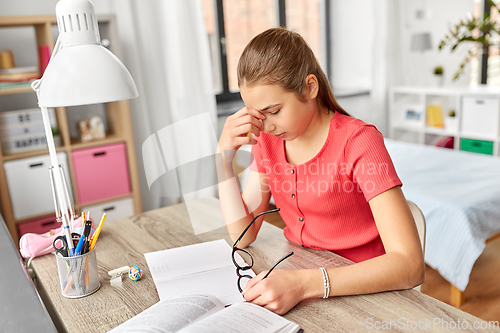 Image of tired teenage student girl with glasses at home