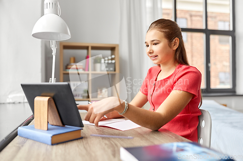 Image of student girl with tablet pc learning at home