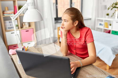 Image of student girl with laptop computer learning at home
