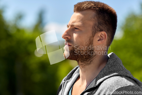 Image of portrait of young man outdoors