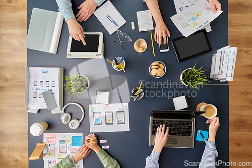 Image of business team with gadgets working at office table