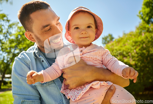 Image of happy father with baby daughter at summer park