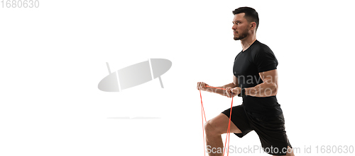 Image of Caucasian professional sportsman training isolated on white studio background. Muscular, sportive man practicing.