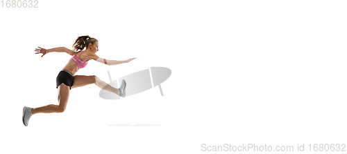 Image of Caucasian professional female runner, athlete training isolated on white studio background. Copyspace for ad.