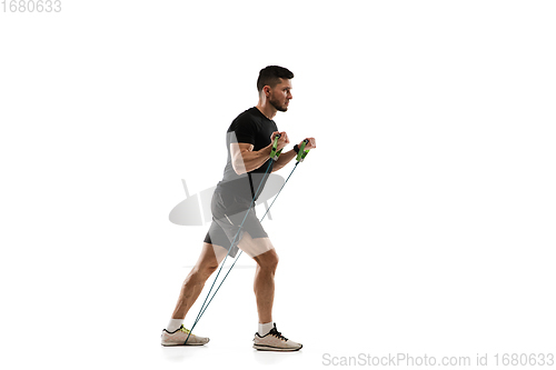 Image of Caucasian professional sportsman training isolated on white studio background. Muscular, sportive man practicing.