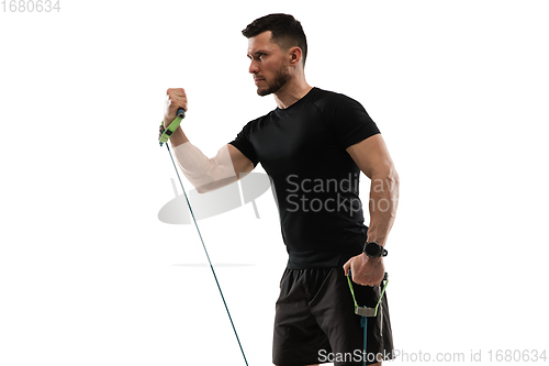 Image of Caucasian professional sportsman training isolated on white studio background. Muscular, sportive man practicing.